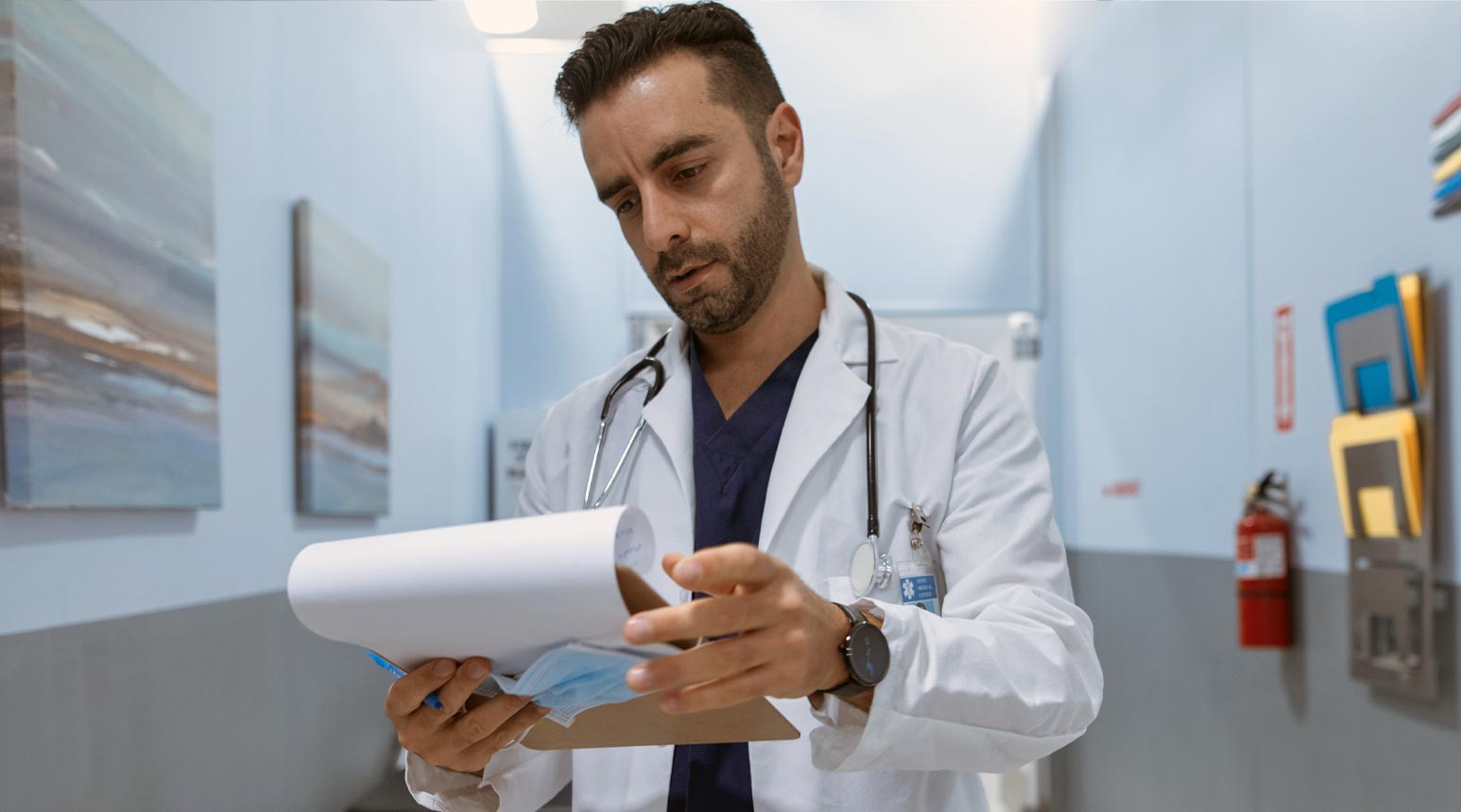 A doctor looking at a chart.