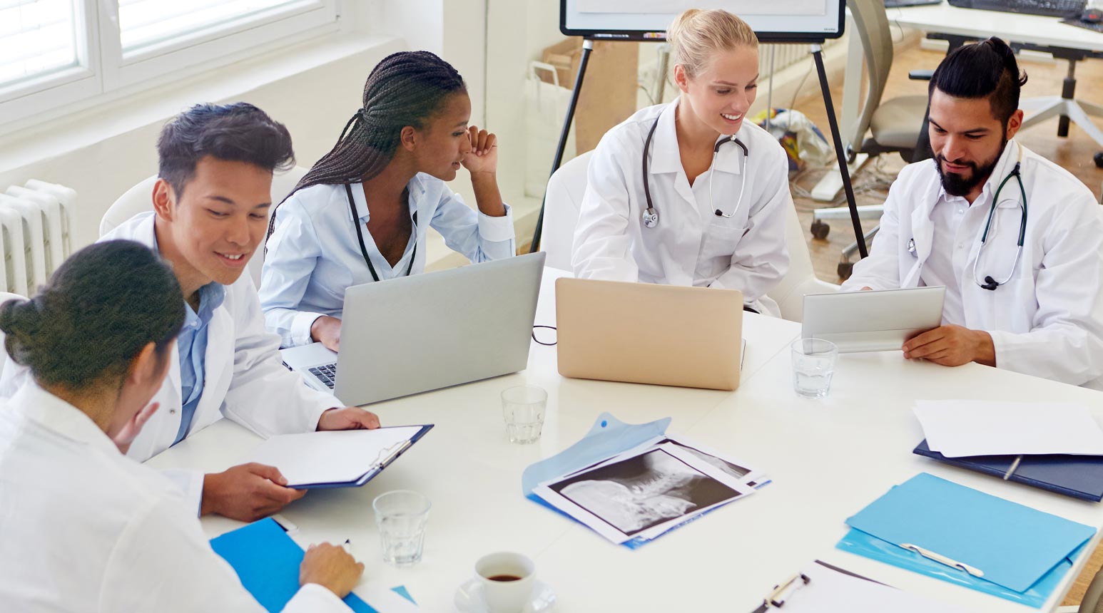 A group of medical professionals around a table.