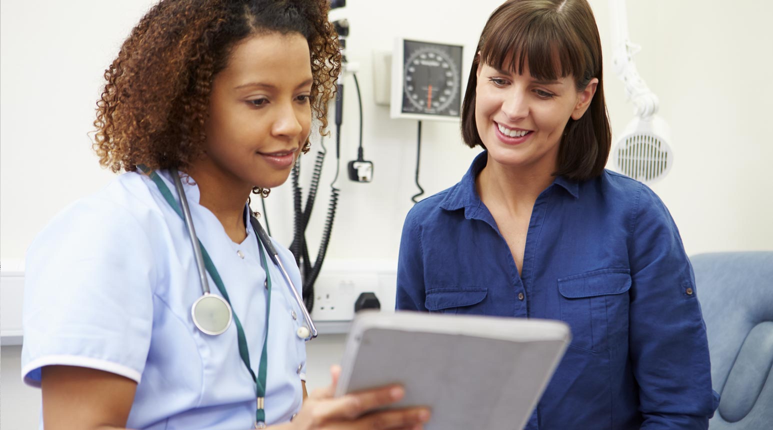 A medical professional and patient discussing information.