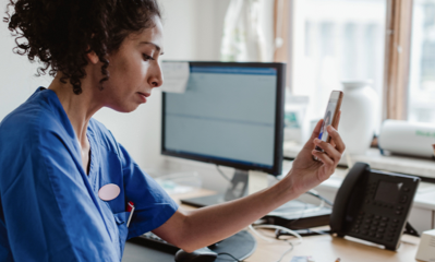 A medical professional working at a desk.
